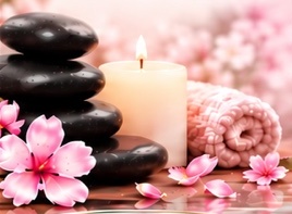 Spa stones, candle, and cherry blossoms from our brochure